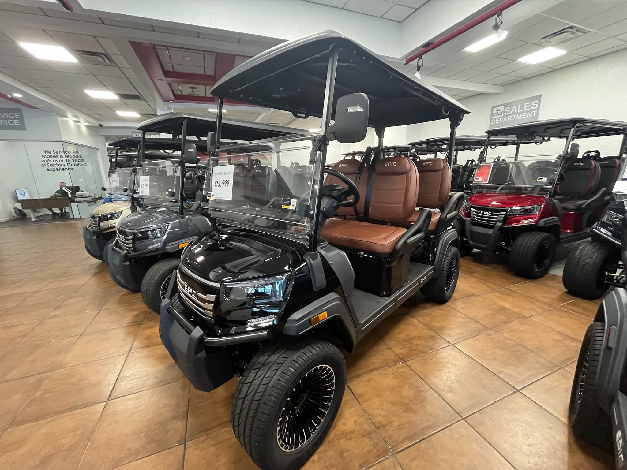 Rows of EPIC carts inside the Pinellas Park showroom, sales department in the background
