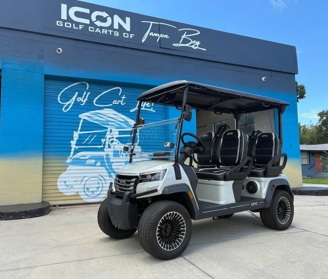 White EPIC cart parked in front of the Icon Golf Carts of Tampa Bay building