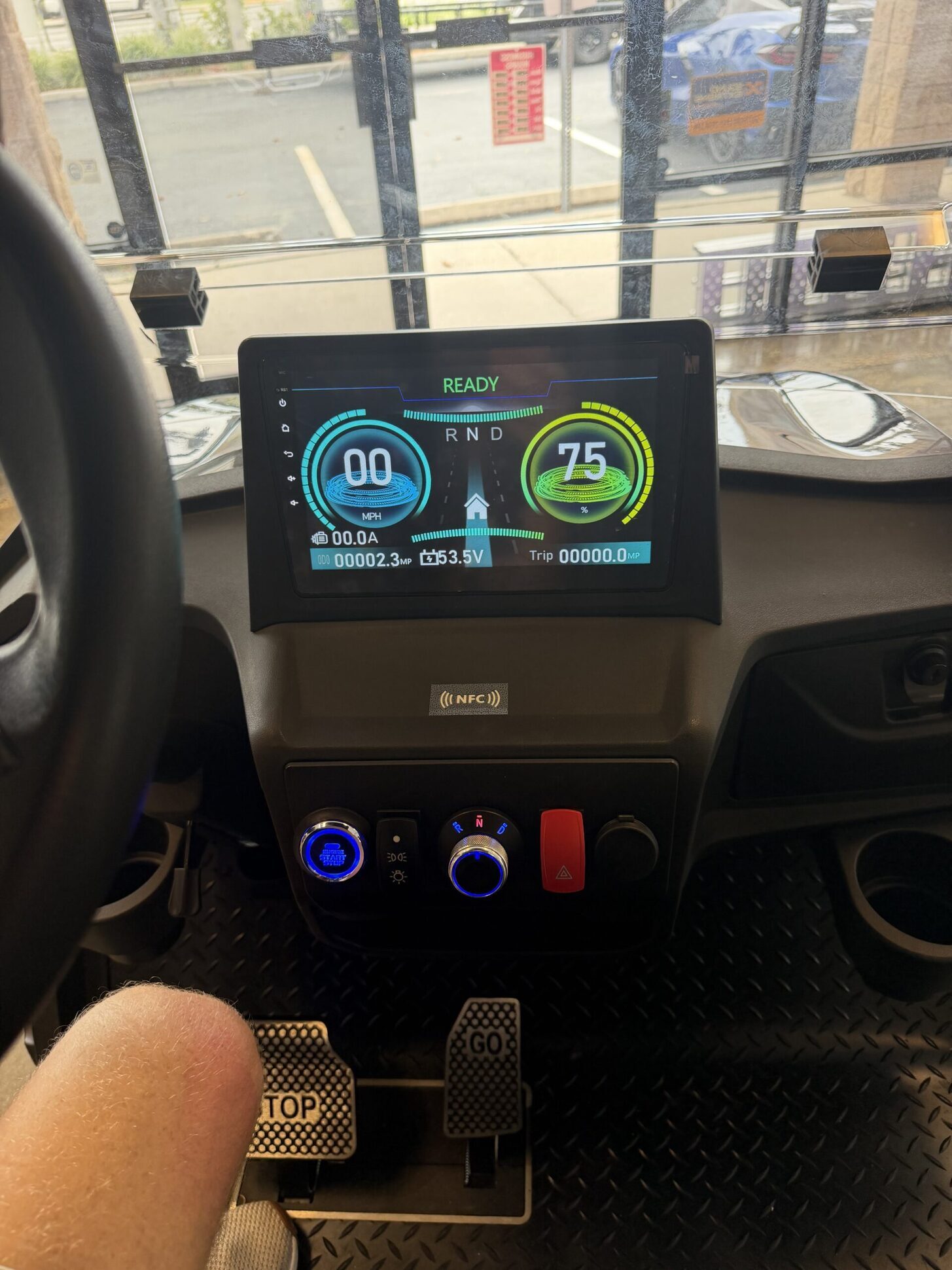 Golf cart touchscreen dashboard lit with a blue and green ready display