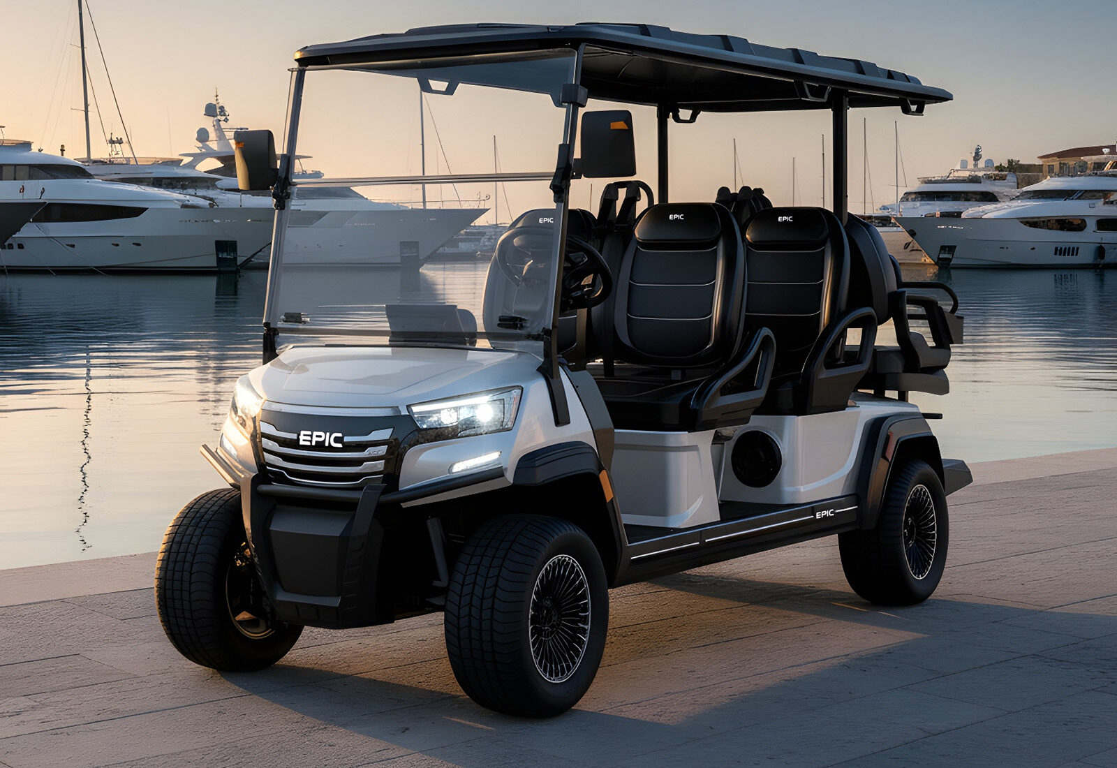 White EPIC six-seat golf cart at a golden-hour marina