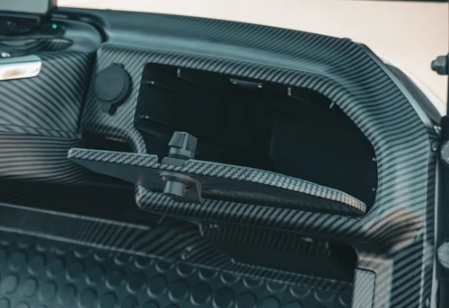 Opened driver-side locking glove box on EPIC E40L with textured carbon finish