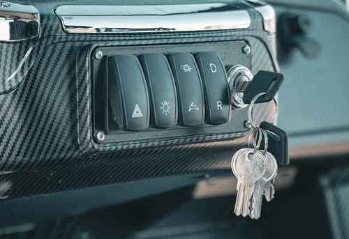 Keyed toggle panel on EPIC E40L dash with auxiliary light and soundbar switches