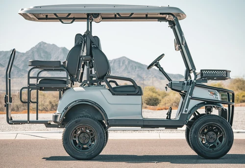 Full side view of EPIC E40L lifted electric cart in silver with basket and grab bar
