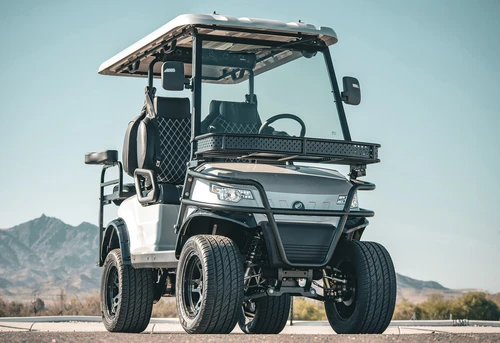 Front view of EPIC E40L with lifted bumper, soundbar, and tubular frame against mountains