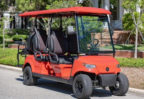 2025 EPIC E60 6-passenger golf cart in red with diamond-stitched seats, glass windshield, and street tires parked curbside in residential neighborhood