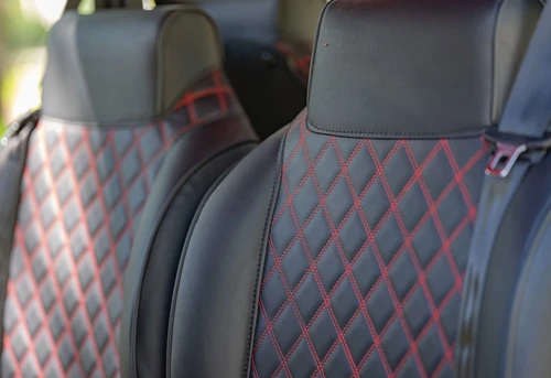 Close-up of EPIC E60 seat backrest featuring diamond-stitched marine-grade vinyl with red accents