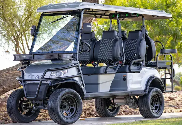 2025 EPIC E60L 6-passenger electric golf cart in white with diamond-stitched seats, glass windshield, black rims, and street tires – front angle view