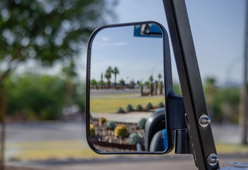 Driver side rearview mirror reflecting golf course on ICON i40 cart