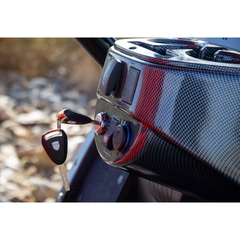 ICON key in ignition on carbon fiber dash – startup and security system close-up