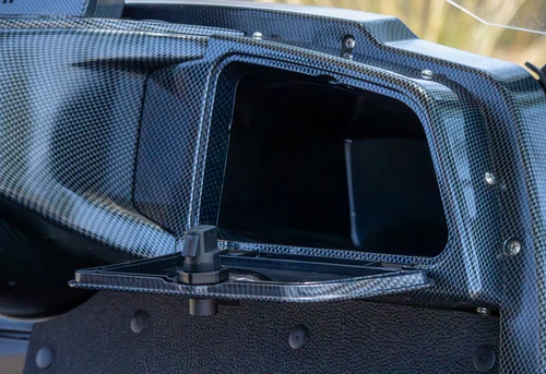 Open storage compartment with carbon fiber trim in ICON i60 golf cart