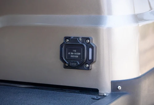 Charging port located on rear side panel of ICON i60 golf cart