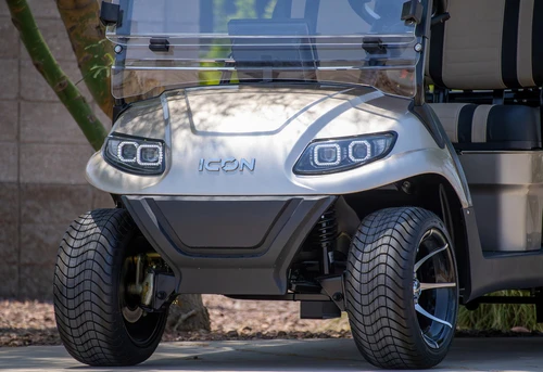 Front view of ICON i60 golf cart in champagne metallic - LED headlights and lifted street tires