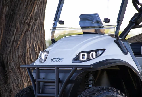 Close-up of 2025 ICON i60L lifted golf cart front end with tubular bumper and signature LED headlights